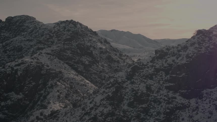 The sun is nearly set over the mountain range