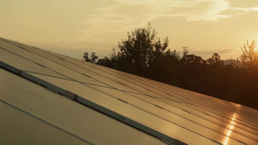 The sun sets over solar panels