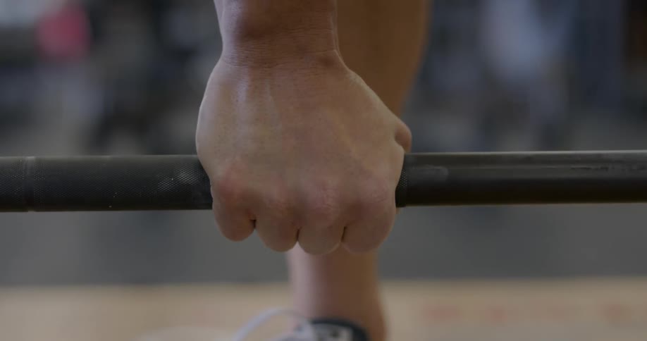 Man grips a barbell