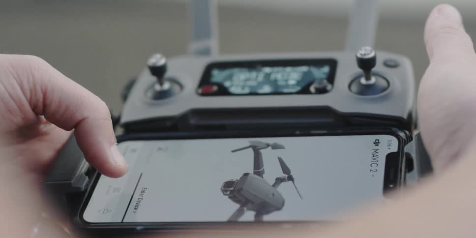 A person holds a drone controller