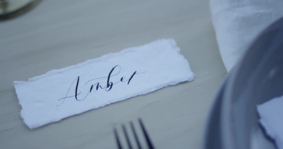 A placemat is on the dining table that says amber
