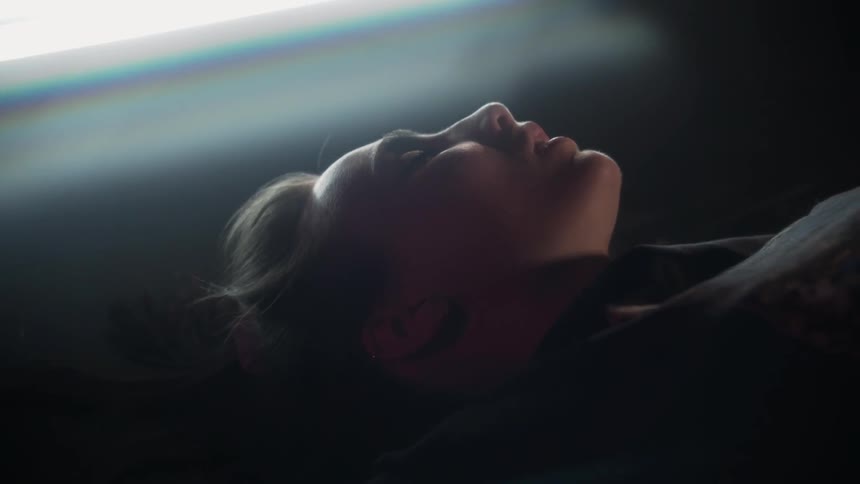 A woman is resting with her eyes closed