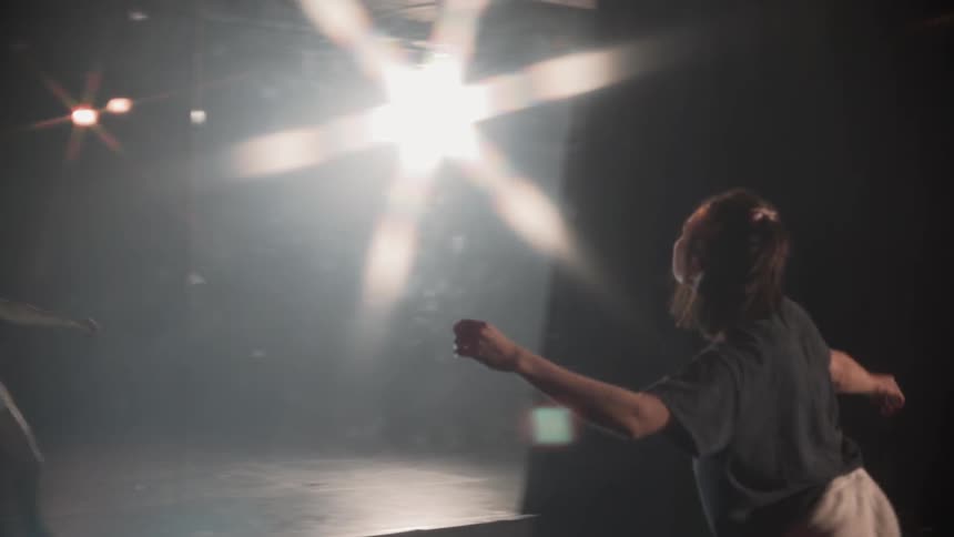 A woman dances in front of the mirror
