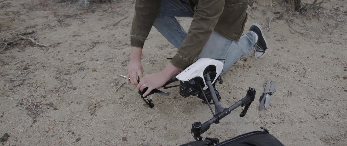 A man is attaching the blade on a drone