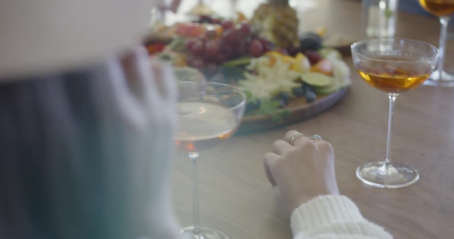 Friends drink and eat snacks at a social gathering