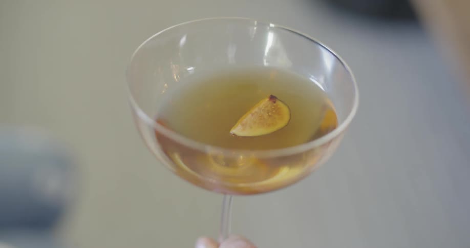 A person is holding a drink in their hand