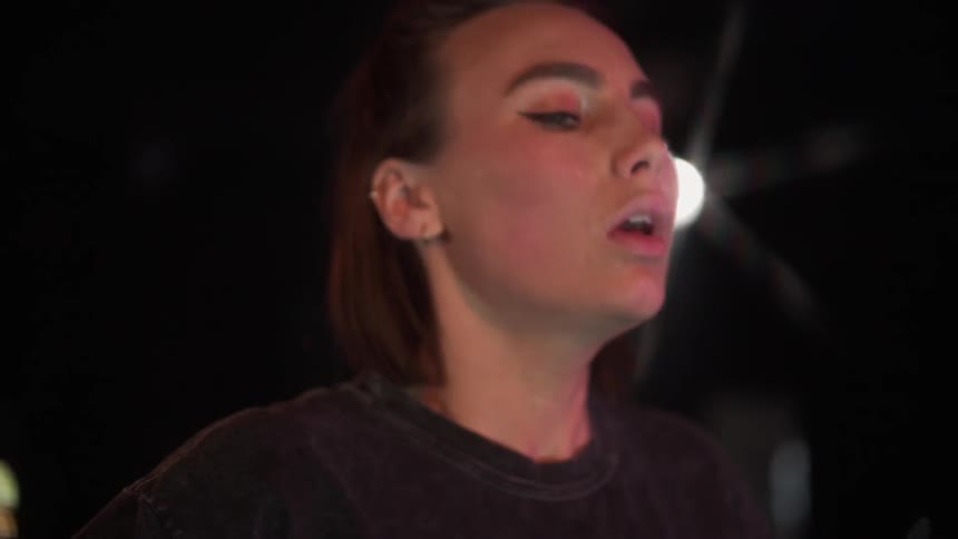 Woman breathes heavily and looks down