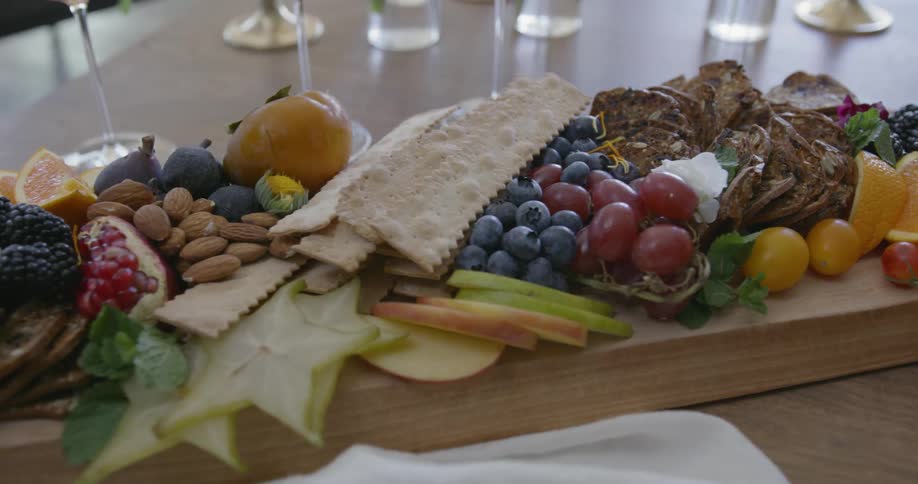 Piles of food on a large cutting board on a table