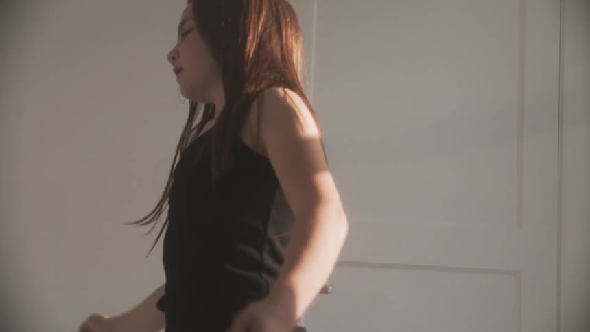 A girl dances at home