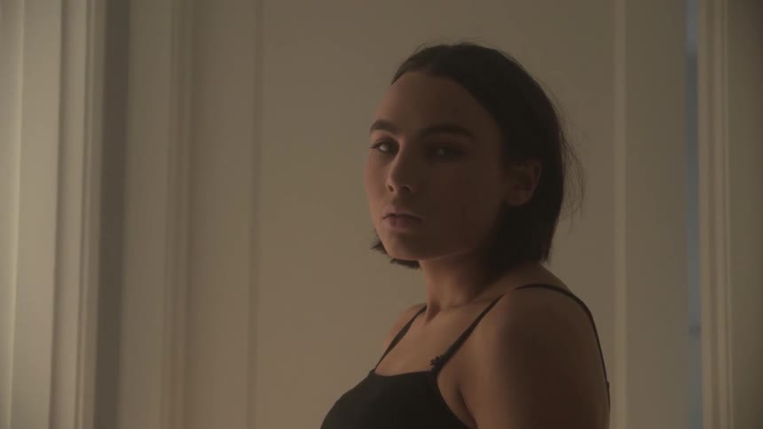 A woman looks to her side in the home