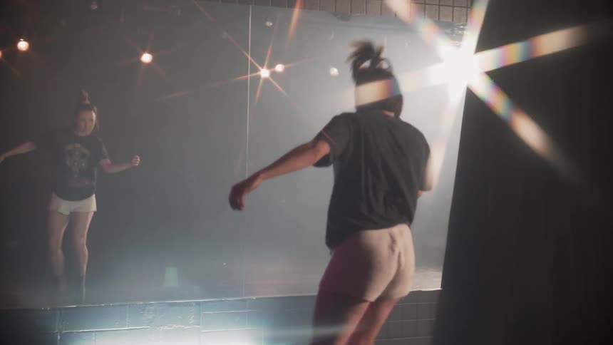 The woman runs up and starts to dance