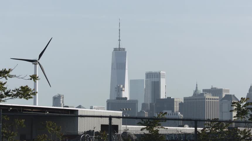 A wind turbine stands in a city