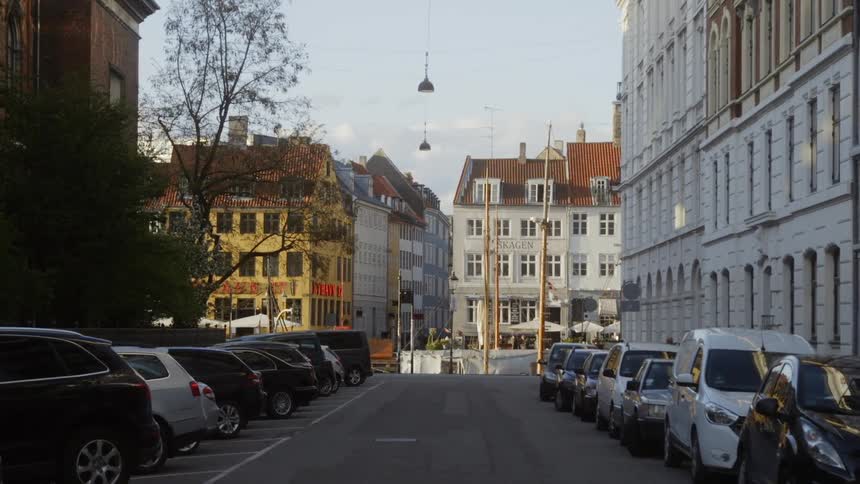 Cars are parked on both sides of a city street