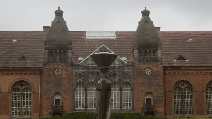 A fountain flows in front of a building