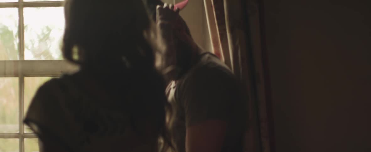 Man puts on a hat and a woman removes it