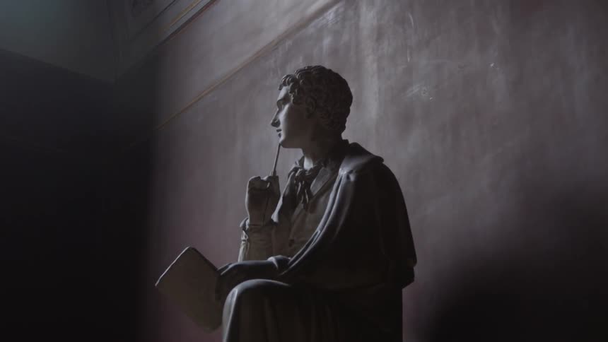 A statue of a man sits in the corner of the room
