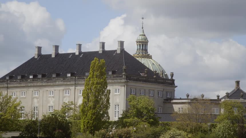 The tall building has a dome on the side