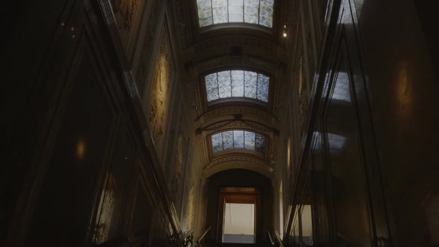 The stairwell is dark leading to the door