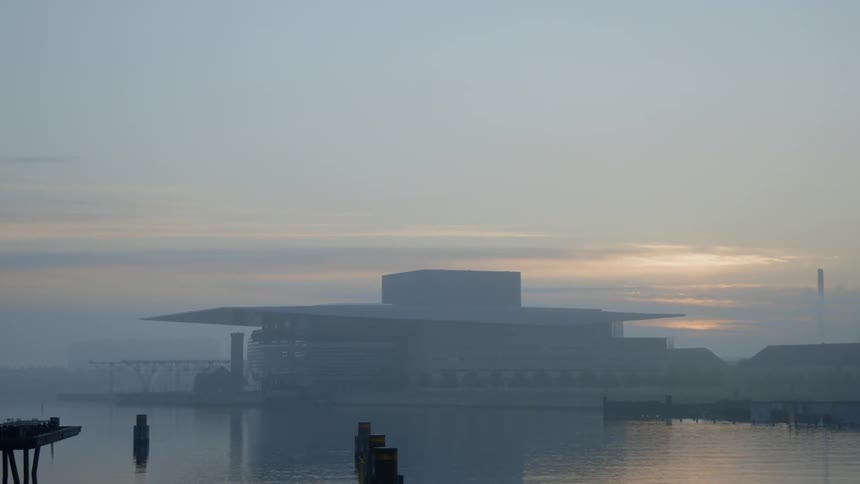 The fog is covering the building over the water