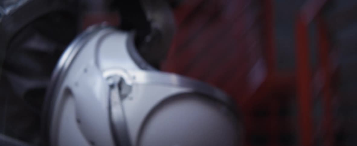 Person carries an astronaut's helmet