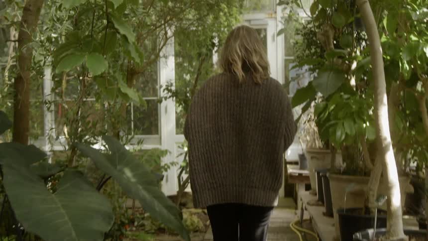 A woman walks over to the house