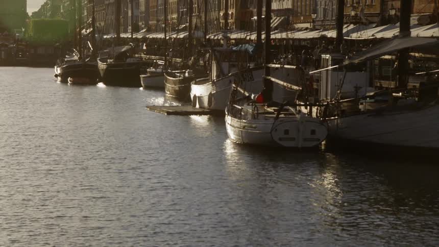 Boats are floating docked in a harbor in copenhagen in daylight