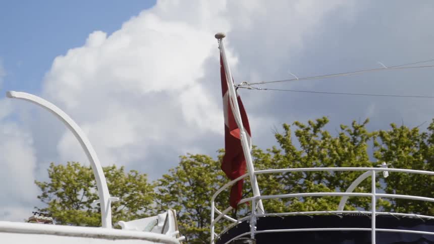 Wind blows a flag on a boat