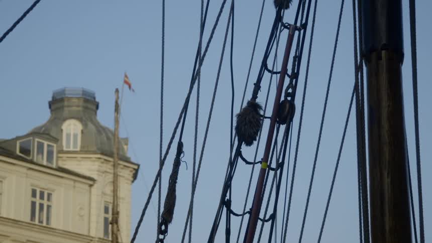 A ship floats near a building