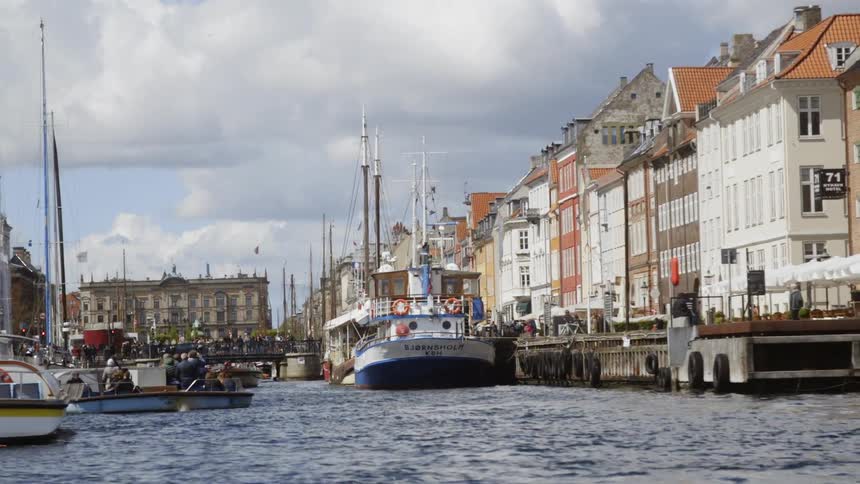 Boats sit in the water and docked in the canal