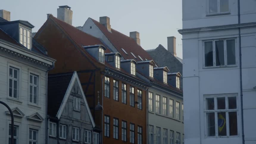 The sun is rising over the buildings