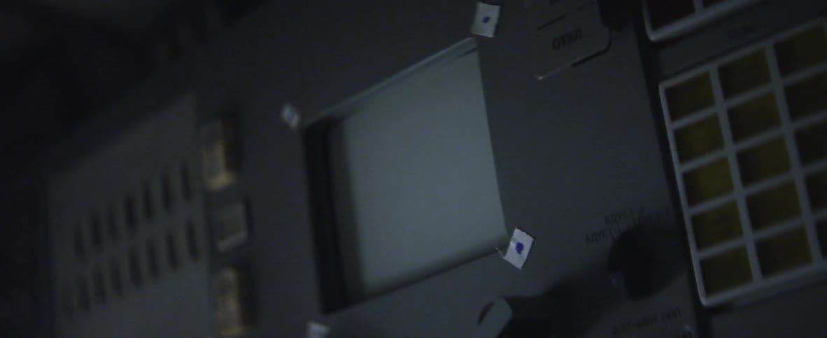A gloved fist knocking on a screen