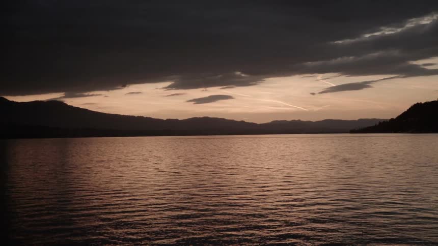 Water flows in a lake at sunset