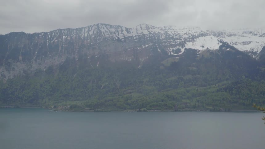 The fog is rolling over the mountain by the lake