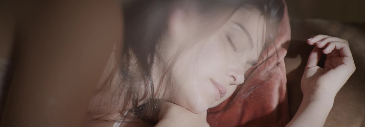 A woman lays in bed