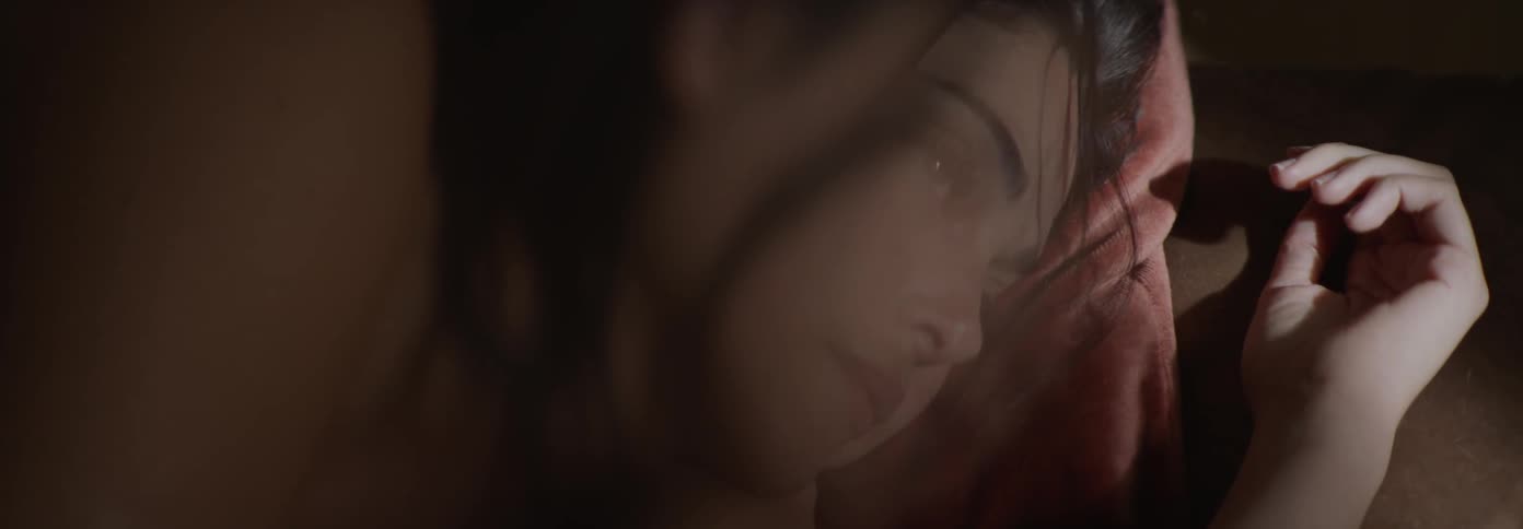 Woman opens her eyes while light shines