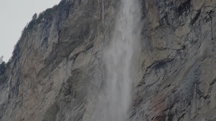 The waterfall is high on top of the cliff