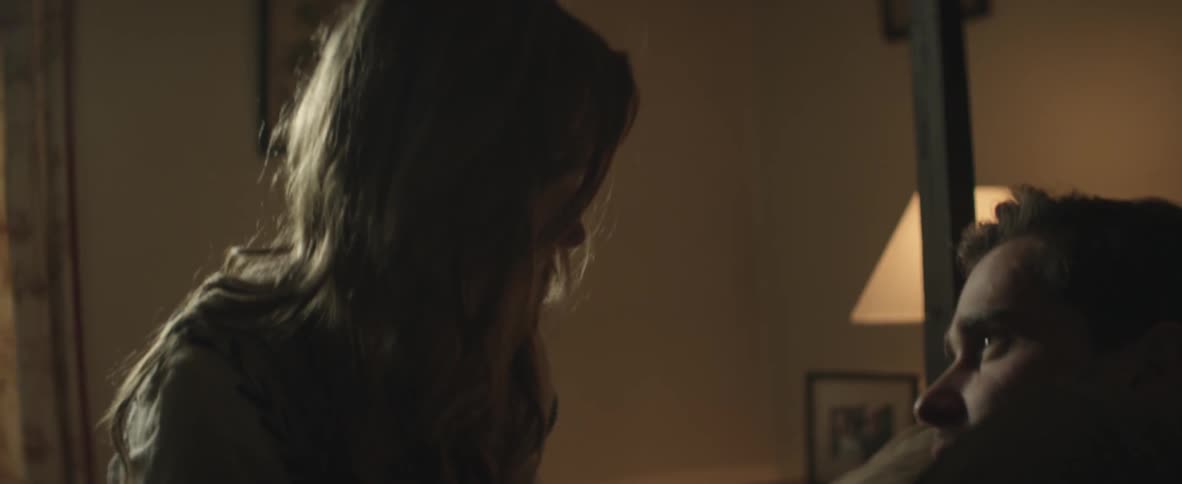 Man and woman talk on a bed