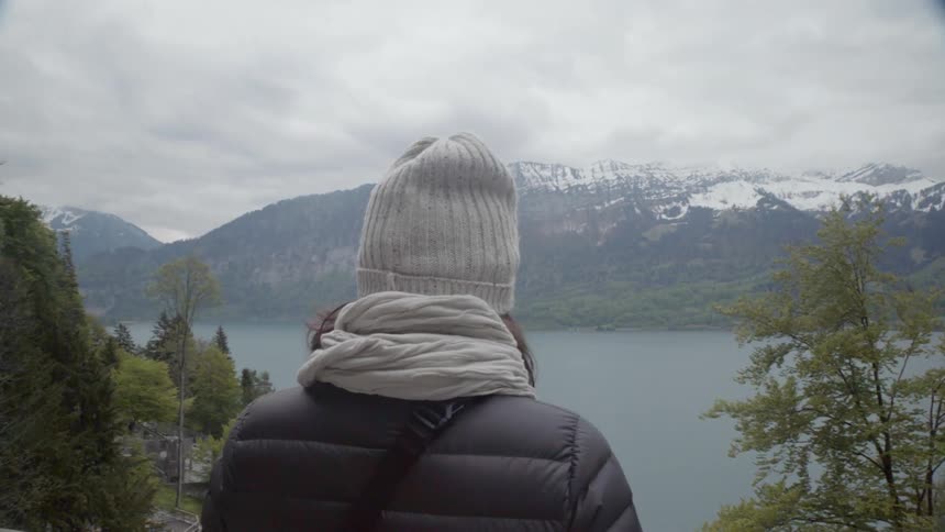 The woman takes in the view of the lake