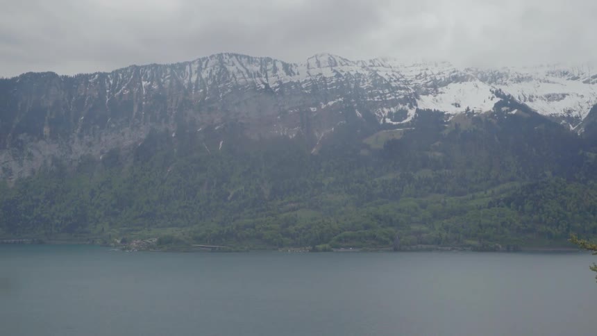 Clouds roll over hills and a body of water