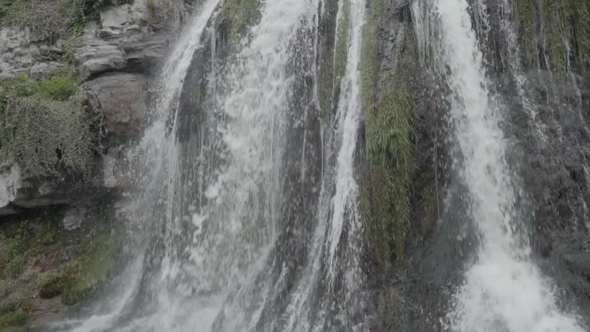 Water rushes down over rock on a waterfall