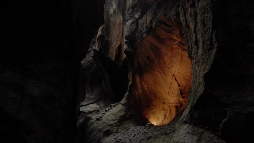 Light reflects off rock walls in a canyon