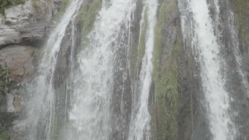 The waterfall is pouring water by the bridge