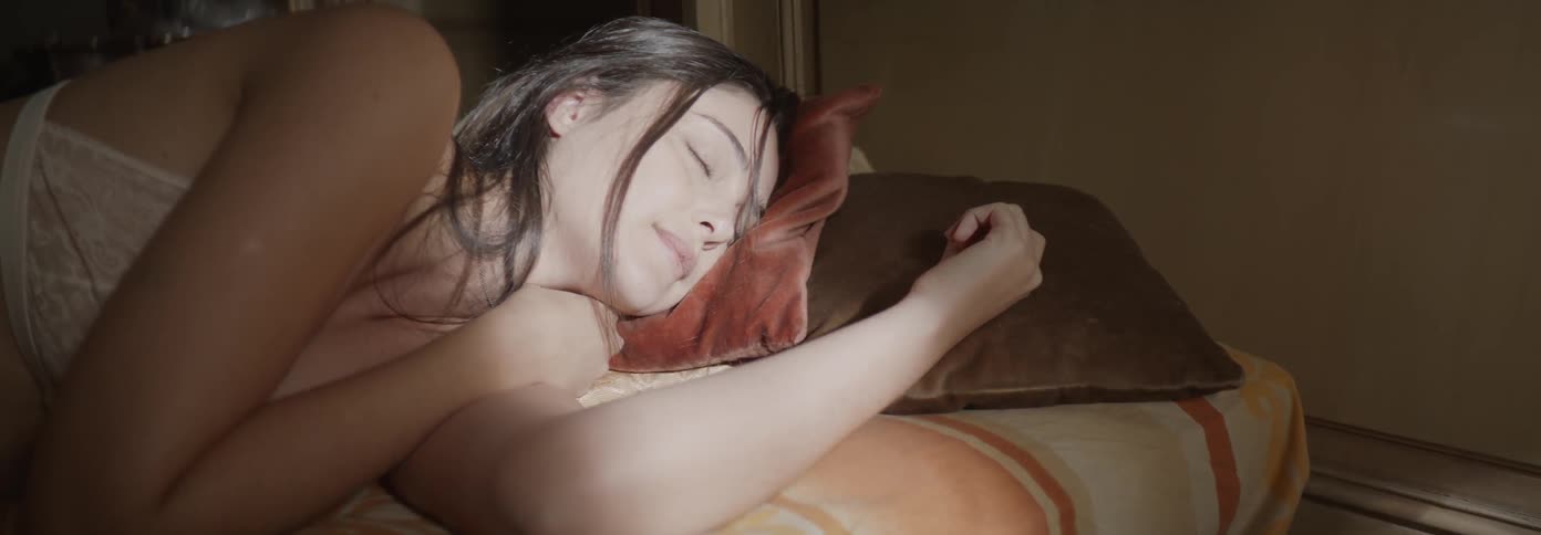 A woman sleeps in a bed