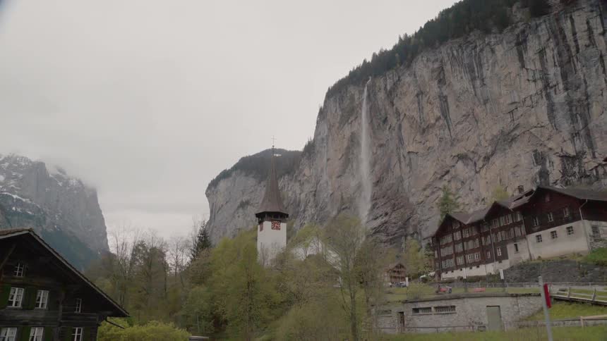 The tall cliff has houses down by the edge