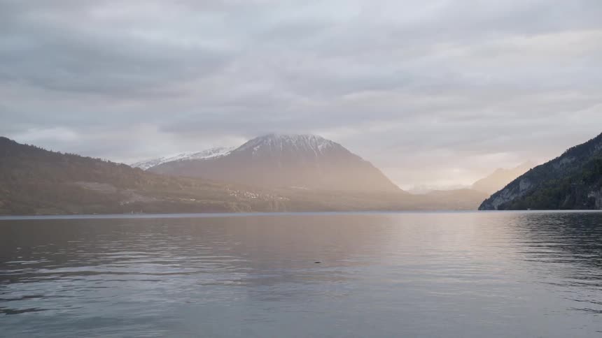Water flows in the lake by the mountains