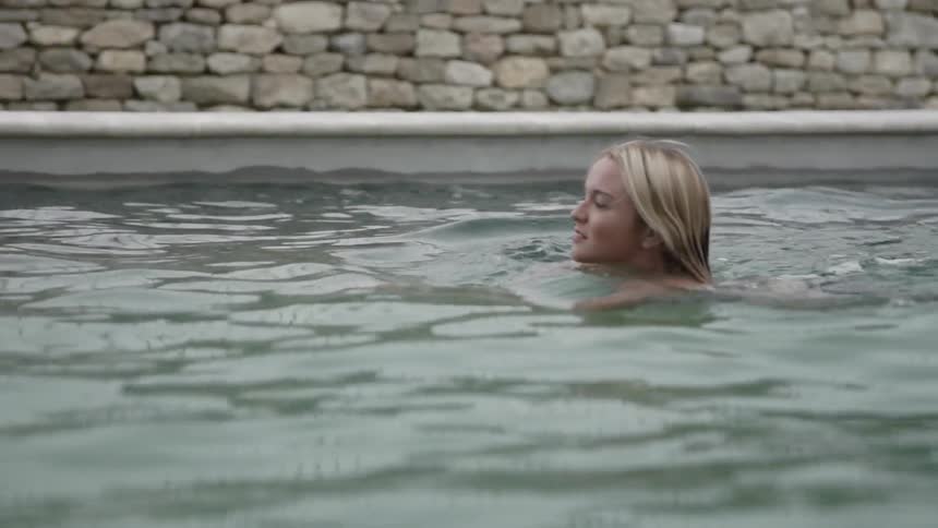 A woman swims in a pool