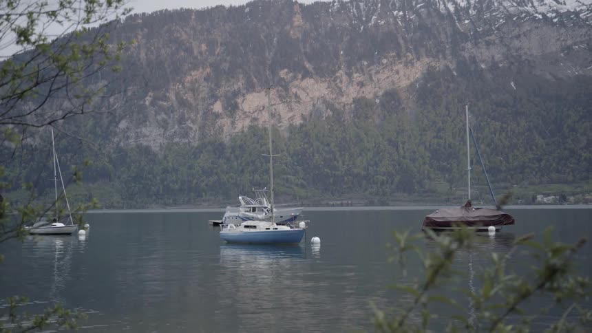 Boats sit in the calm lake waters