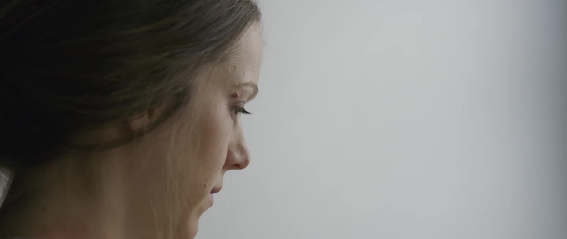 A woman looks down at something