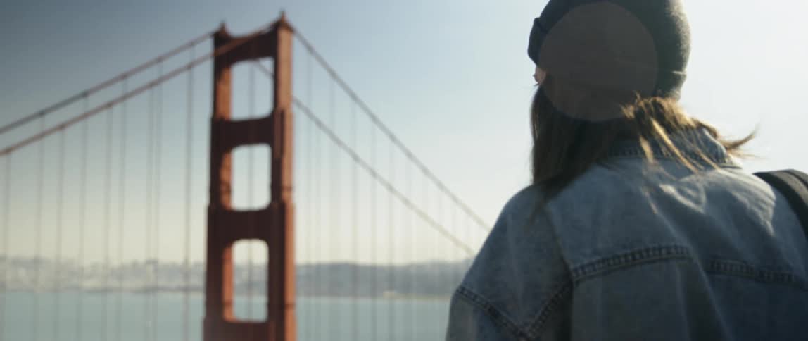 A woman looks towards the golden gate bridge