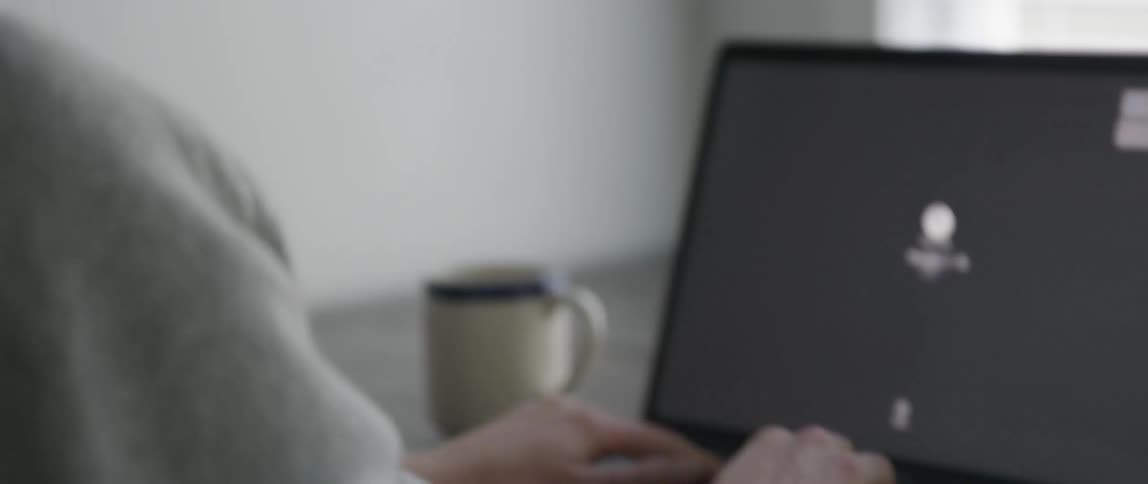 A woman types on a laptop